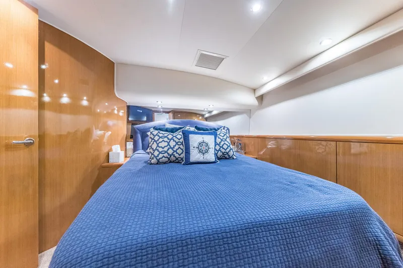 Scales Of Justice Yacht Photos Pics Luxurious cabin interior of 1999 Hatteras 60 Convertible yacht with blue bedding.