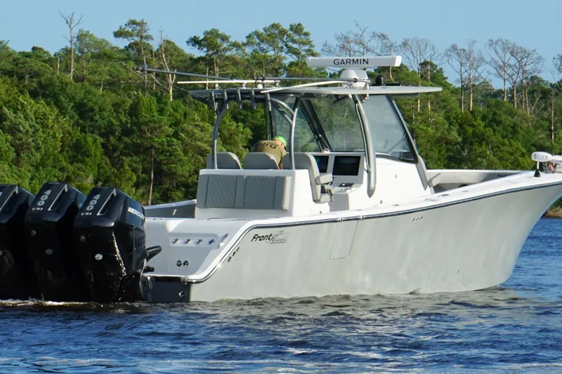  Yacht Photos Pics 2024 Front Runner 39 Center Console boat with multiple outboard engines on a scenic waterway.