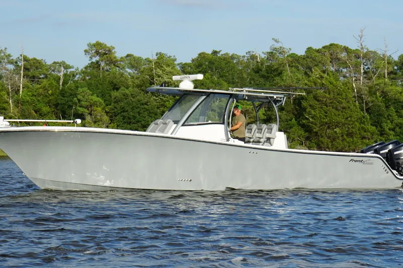  Yacht Photos Pics 2024 Front Runner 39 Center Console boat cruising on a scenic waterway.