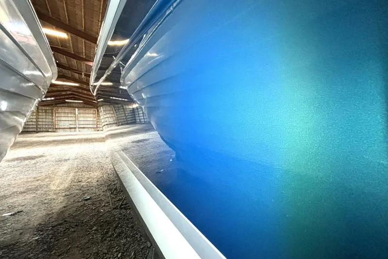  Yacht Photos Pics Blue hull of a 2006 Formula 400 Super Sport Crossover boat in storage.