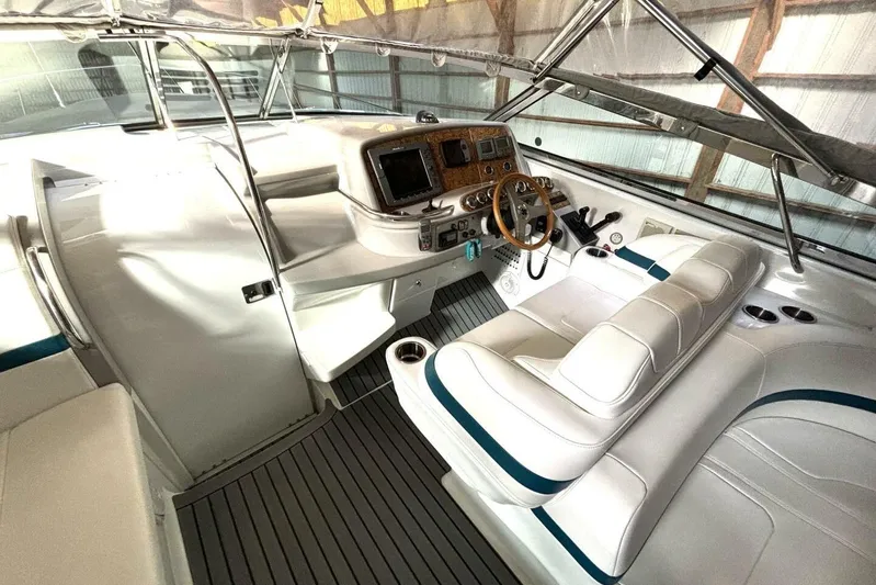  Yacht Photos Pics Interior of a 2006 Formula 400 Super Sport Crossover boat with white seating and control panel.