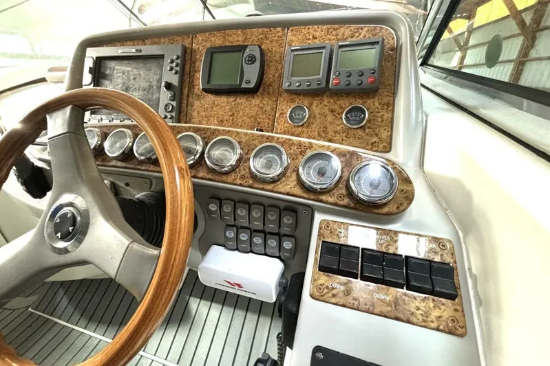  Yacht Photos Pics Control panel of a 2006 Formula 400 Super Sport Crossover boat with wood accents and gauges.