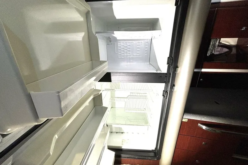  Yacht Photos Pics Open refrigerator inside a 2006 Formula 400 Super Sport Crossover boat, showing empty shelves.