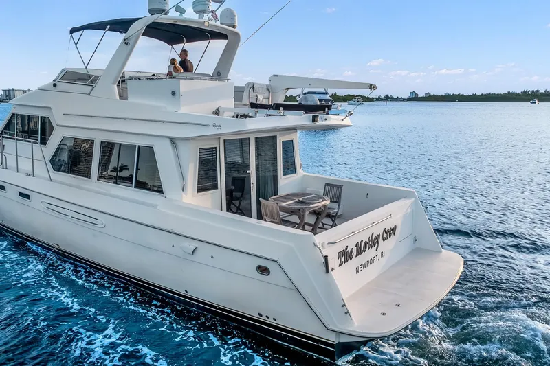 Motely Crew Yacht Photos Pics Luxury yacht Navigator Rival 5700 cruising on blue waters, 2003 model.