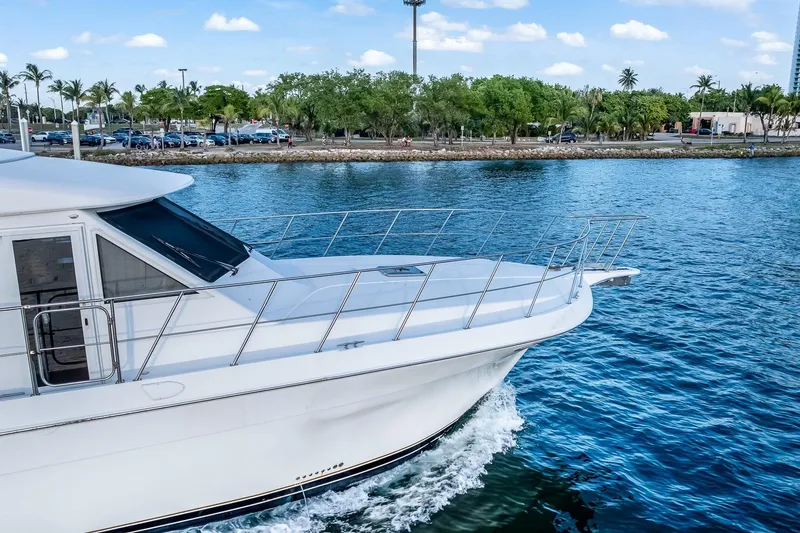 Motely Crew Yacht Photos Pics 2003 Navigator Rival 5700 yacht cruising on a scenic waterway.