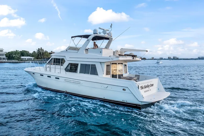 Motely Crew Yacht Photos Pics Luxury yacht Navigator Rival 5700 cruising on blue ocean waters, 2003 model.