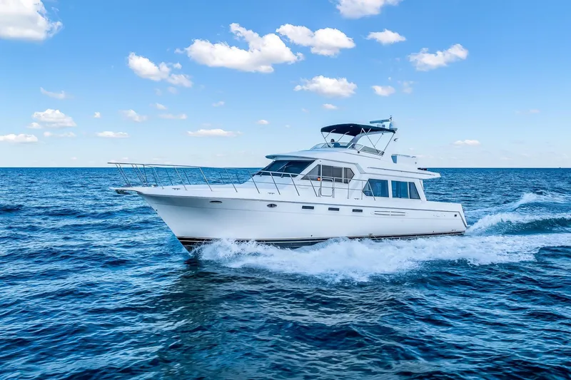 Motely Crew Yacht Photos Pics 2003 Navigator Rival 5700 yacht cruising on open sea under blue sky.