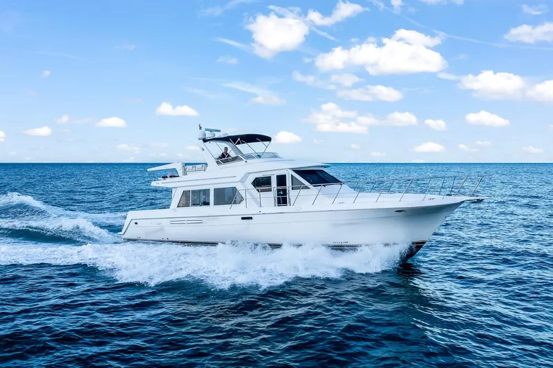 Motely Crew Yacht Photos Pics 2003 Navigator Rival 5700 yacht cruising on open sea under blue sky.
