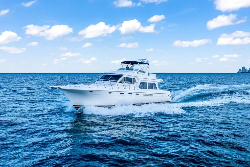 Motely Crew Yacht Photos Pics 2003 Navigator Rival 5700 yacht cruising on open blue sea under clear sky.