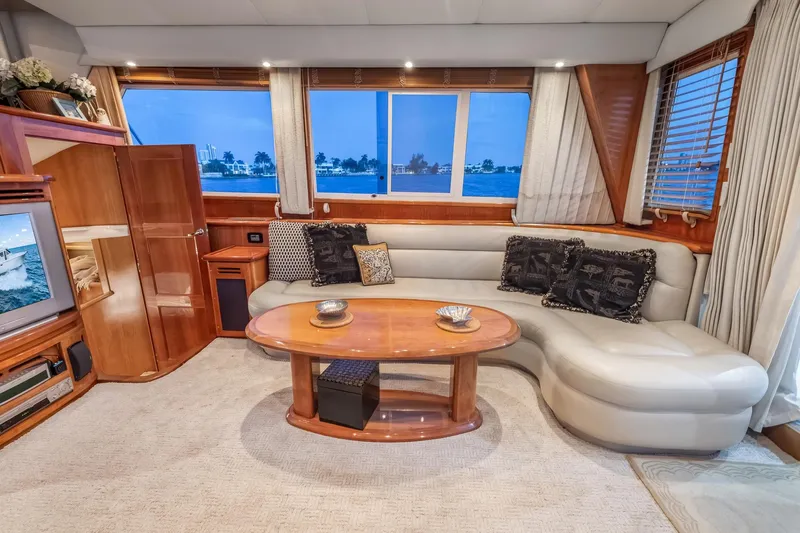 Motely Crew Yacht Photos Pics Luxurious 2003 Navigator Rival 5700 yacht interior with elegant seating and panoramic windows.