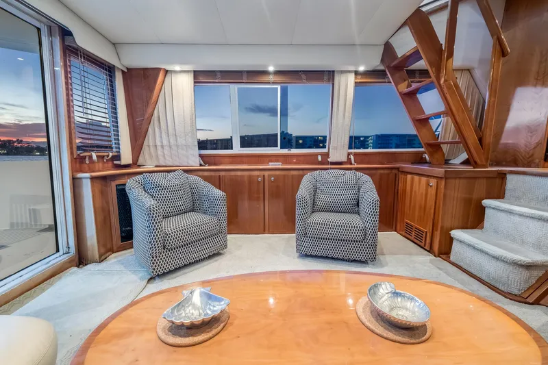 Motely Crew Yacht Photos Pics Luxurious 2003 Navigator Rival 5700 yacht interior with elegant seating and wooden accents.