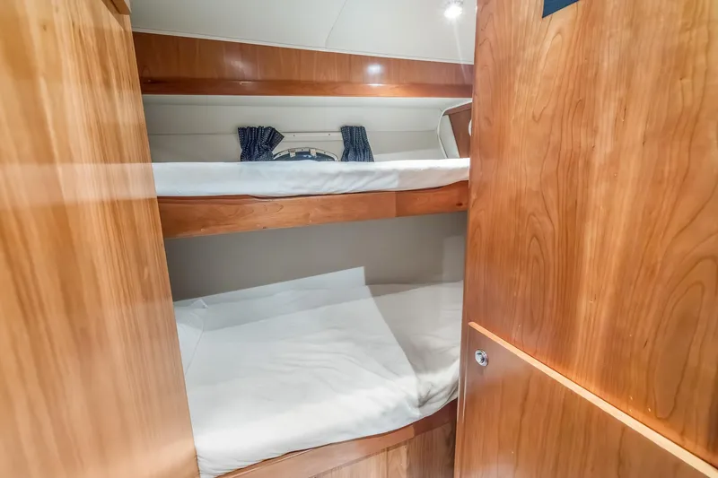 Motely Crew Yacht Photos Pics Bunk beds in 2003 Navigator Rival 5700 yacht cabin with wooden interior.