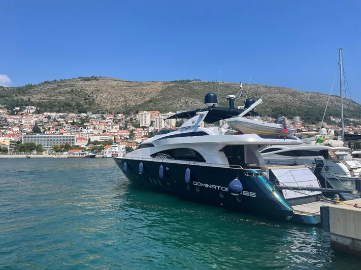 Nike Yacht Photos Pics Luxury yacht Dominator 860, 2007 model, docked in scenic coastal marina.