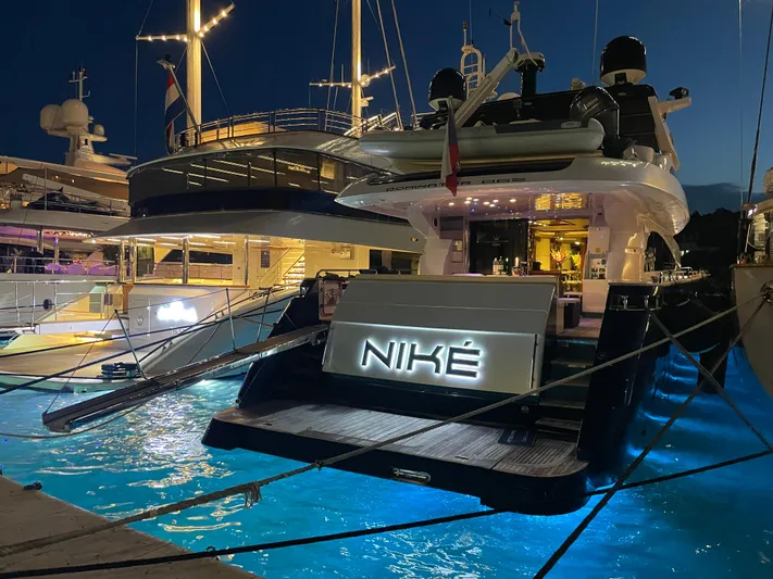 Nike Yacht Photos Pics Luxurious 2007 Dominator 860 yacht docked at night, illuminated with elegant lighting.