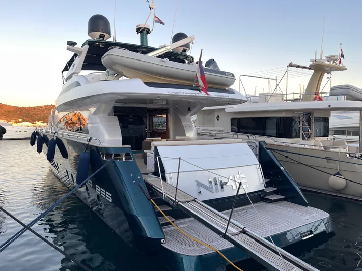 Nike Yacht Photos Pics Luxury yacht Dominator 860, 2007 model, docked at marina during sunset.