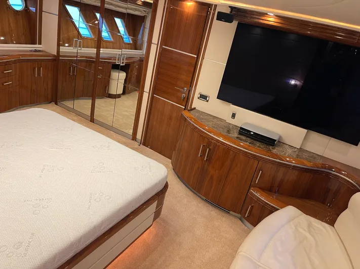 Nike Yacht Photos Pics Luxurious bedroom interior of 2007 Dominator 860 yacht with wood finishes and large TV.