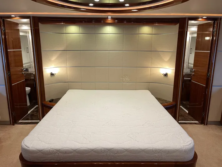Nike Yacht Photos Pics Luxurious bedroom interior of 2007 Dominator 860 yacht with elegant wood accents.