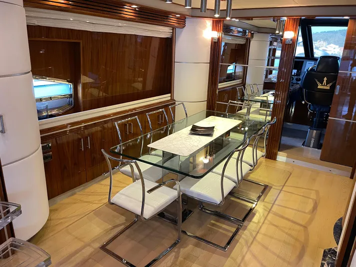 Nike Yacht Photos Pics Luxurious dining area in 2007 Dominator 860 yacht with glass table and modern chairs.