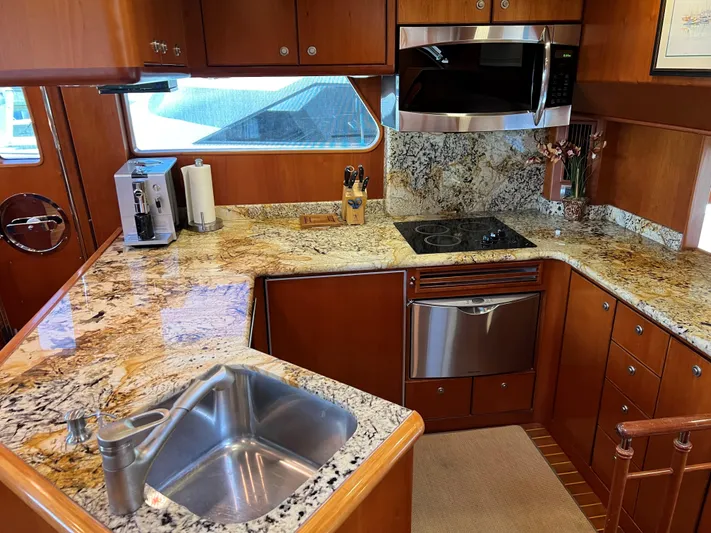 Off Line Yacht Photos Pics Luxurious yacht kitchen with granite countertops, stainless steel appliances, and wooden cabinetry, 2007 Symbol PHMY.