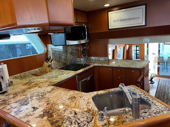 Off Line Yacht Photos Pics Luxurious yacht kitchen with granite countertops, stainless steel appliances, and wooden cabinetry, 2007 Symbol PHMY.