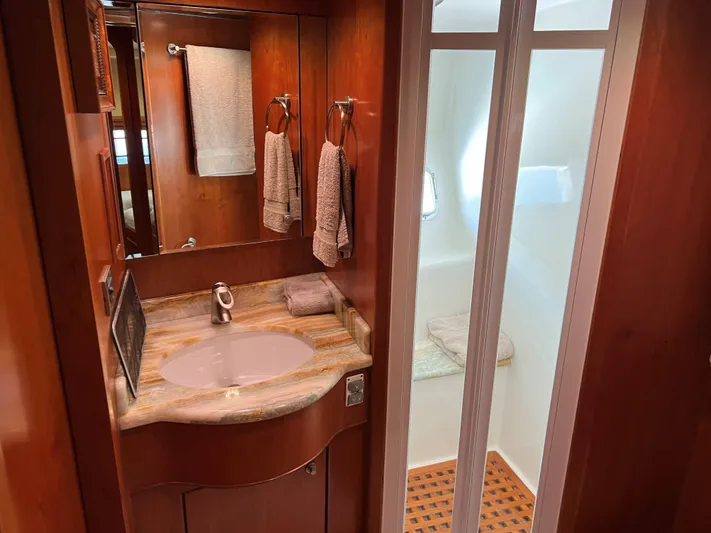 Off Line Yacht Photos Pics Luxurious yacht bathroom with wooden cabinetry, marble sink, and modern fixtures, 2007 Symbol PHMY.