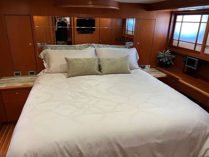 Off Line Yacht Photos Pics Luxurious yacht bedroom with wooden decor, large bed, and elegant bedding, Symbol PHMY 2007 model.