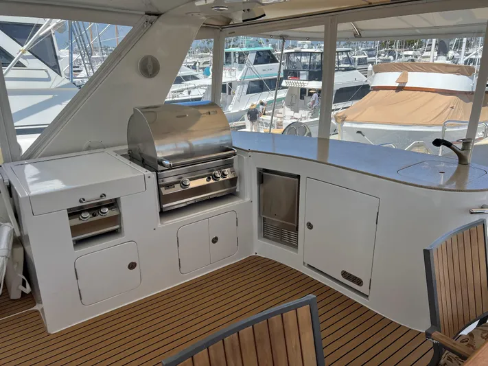 Off Line Yacht Photos Pics Outdoor yacht kitchen with grill and seating, Symbol PHMY 2007 model, docked at marina.