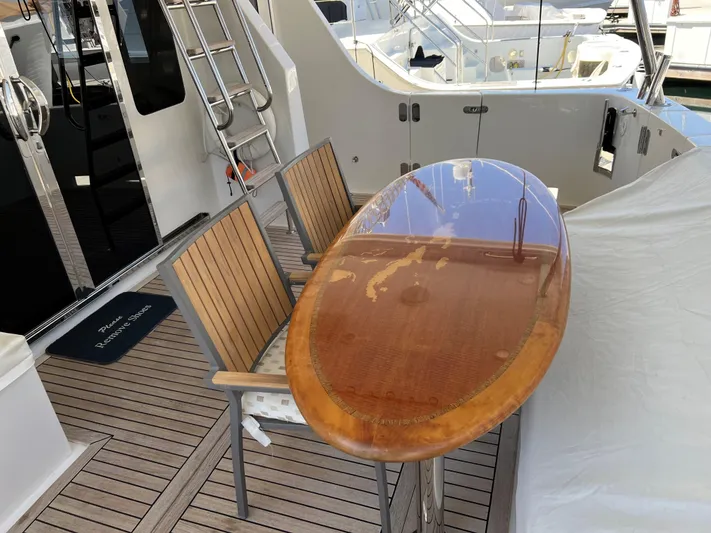 Off Line Yacht Photos Pics Wooden deck with polished surfboard table and chairs on a 2007 Symbol PHMY yacht.