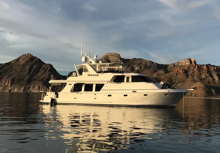 Off Line Yacht Photos Pics Luxury yacht on calm water with mountainous backdrop, Symbol PHMY 2007 model.