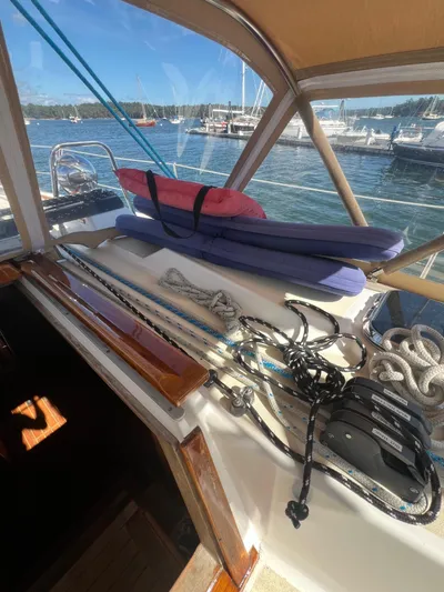  Yacht Photos Pics 2003 Tartan 4100 sailboat deck with ropes and cushions, docked in a marina.