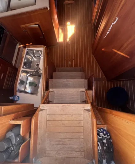  Yacht Photos Pics Interior of 2003 Tartan 4100 sailboat with wooden flooring and compact kitchen area.