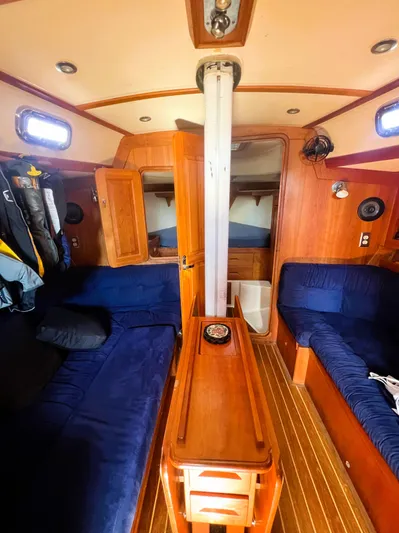  Yacht Photos Pics Interior of 2003 Tartan 4100 sailboat with wooden furnishings and blue seating.