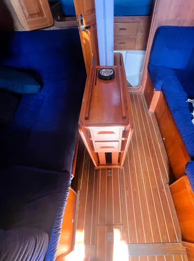  Yacht Photos Pics Interior of 2003 Tartan 4100 sailboat with wooden flooring and blue seating.