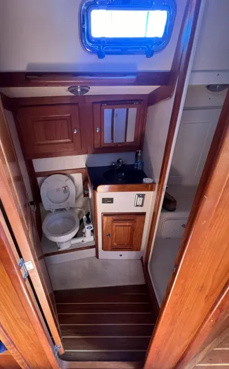  Yacht Photos Pics 2003 Tartan 4100 yacht bathroom with wooden cabinetry and compact design.