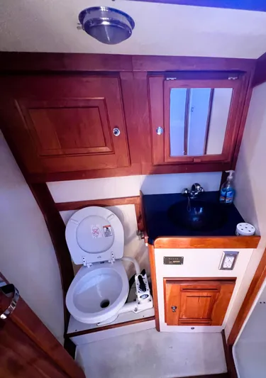  Yacht Photos Pics Compact Tartan 4100 2003 yacht bathroom with wooden cabinets and modern fixtures.