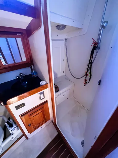  Yacht Photos Pics 2003 Tartan 4100 yacht bathroom with shower and sink area.