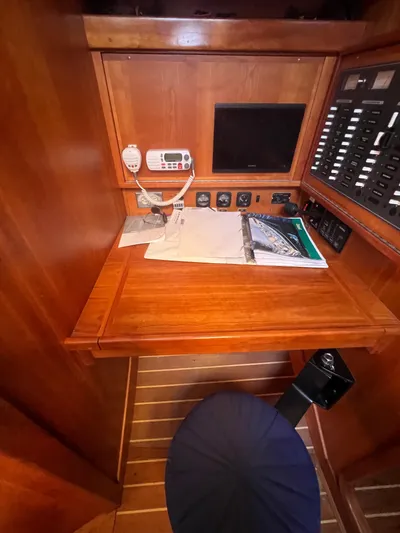  Yacht Photos Pics Navigation station in 2003 Tartan 4100 sailboat with radio, monitor, and control panel.