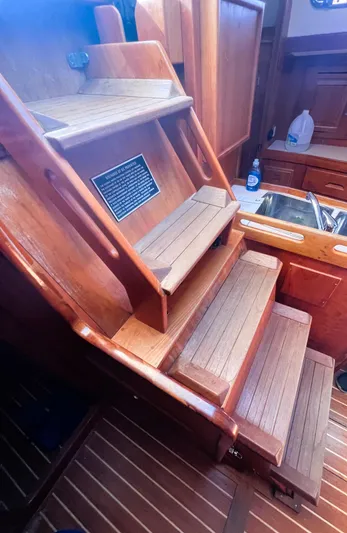  Yacht Photos Pics Wooden interior stairs of a 2003 Tartan 4100 sailboat.