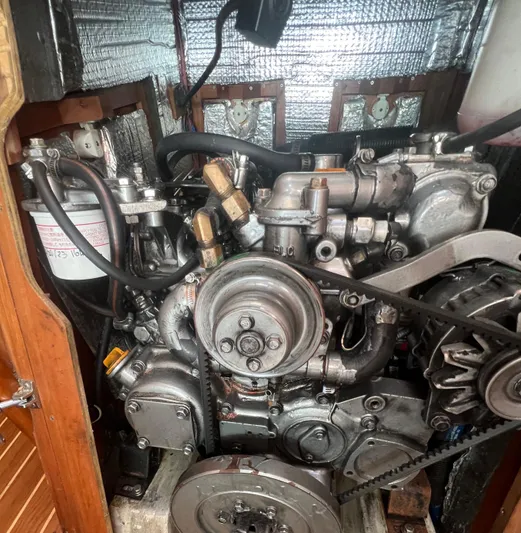  Yacht Photos Pics Engine of a 2003 Tartan 4100 sailboat, showcasing mechanical components and belts.