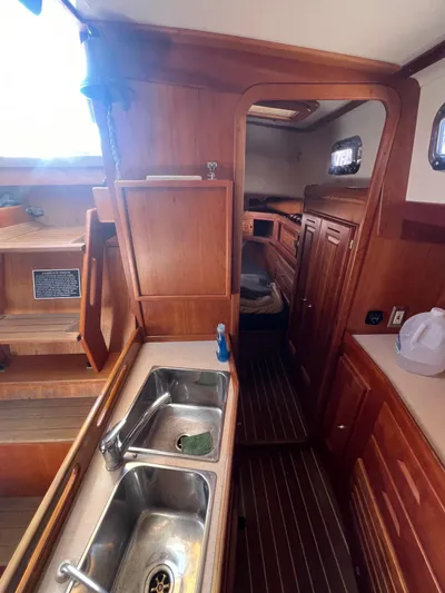  Yacht Photos Pics Interior of 2003 Tartan 4100 sailboat with wooden cabinetry and dual sink.