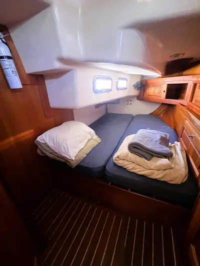  Yacht Photos Pics Cozy cabin interior of 2003 Tartan 4100 sailboat with bedding and wooden accents.