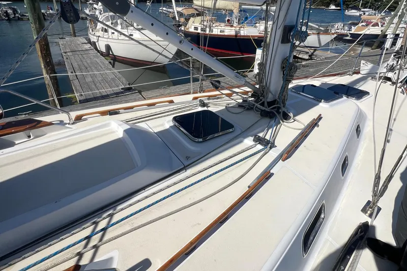  Yacht Photos Pics 2003 Tartan 4100 sailboat deck with rigging and docked boats in background.