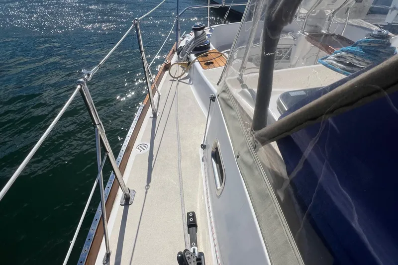  Yacht Photos Pics 2003 Tartan 4100 sailboat deck with railing and winch, sunlit on the water.