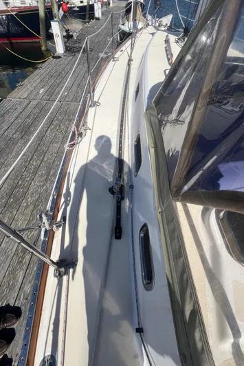  Yacht Photos Pics Shadow on deck of 2003 Tartan 4100 sailboat at marina.