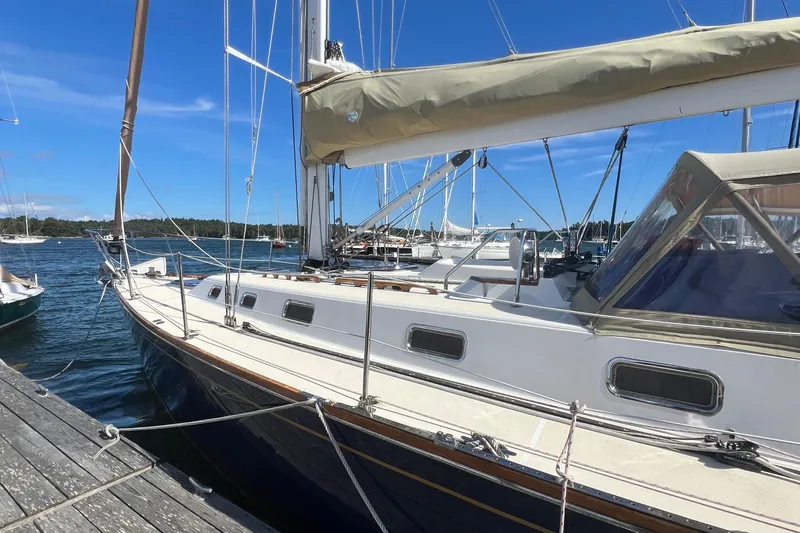  Yacht Photos Pics 2003 Tartan 4100 sailboat docked at marina under clear blue sky.