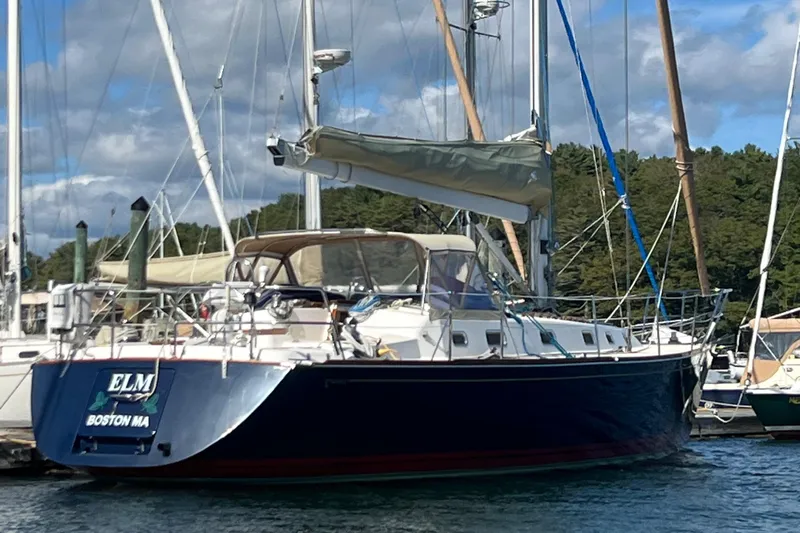  Yacht Photos Pics 2003 Tartan 4100 sailboat docked in marina, Boston MA, under a partly cloudy sky.