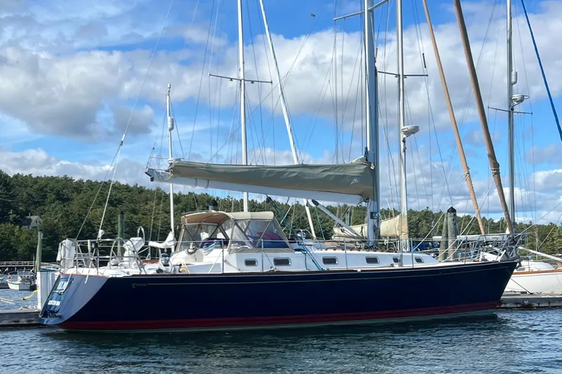 Yacht Photos Pics 2003 Tartan 4100 sailboat docked on a sunny day with blue skies.