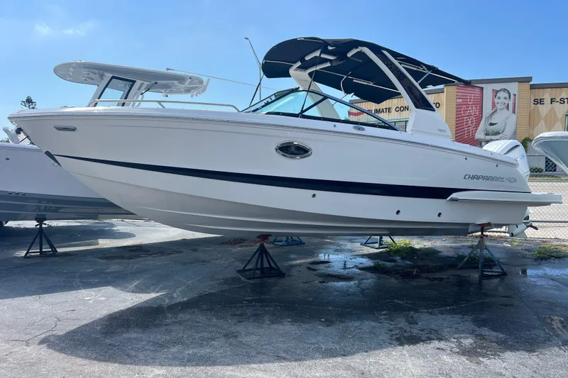  Yacht Photos Pics 2025 Chaparral 270 OSX boat displayed on stands under clear blue sky.