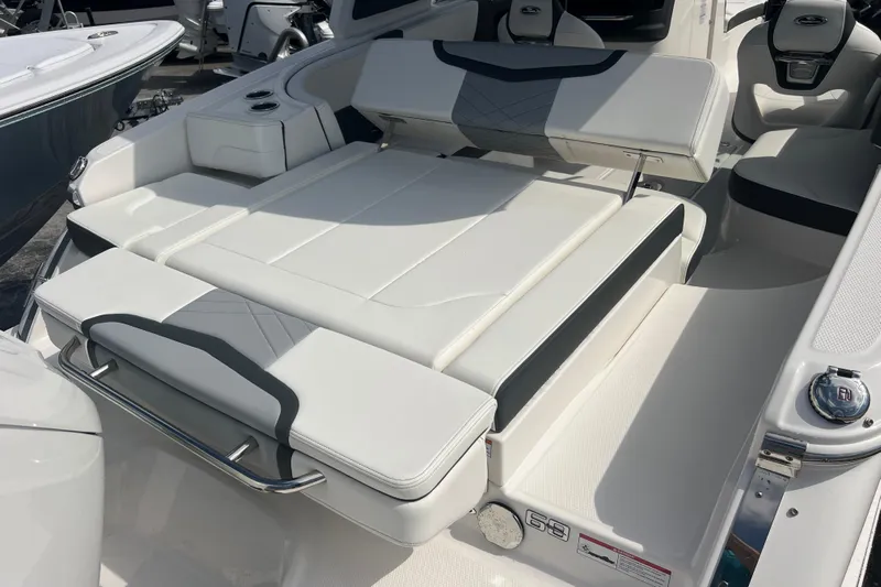  Yacht Photos Pics 2025 Chaparral 270 OSX boat interior with luxurious white seating and modern design.