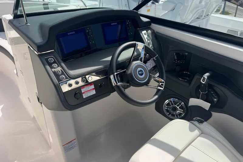  Yacht Photos Pics 2025 Chaparral 270 OSX boat dashboard with steering wheel and control panel.